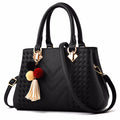Embossed top handle handbag with pompom