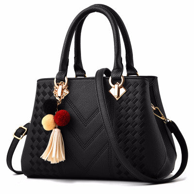 Millie | Embossed handbag with pompom charm and strap