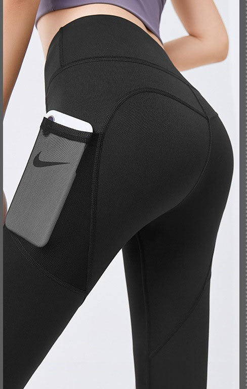 Woman wearing high-waist leggings with phone pocket